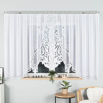 A white lace curtain hanging on a window.