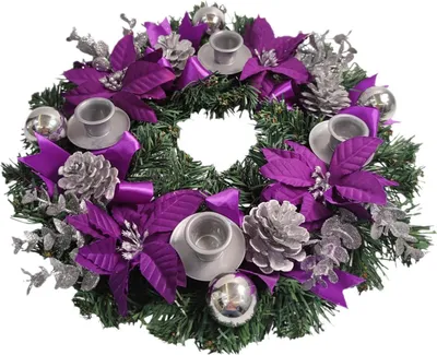 A Christmas advent wreath with purple poinsettias, silver pinecones, ornaments, and candle holders.