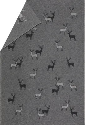 A gray blanket with a repeating pattern of deer silhouettes in black and white.