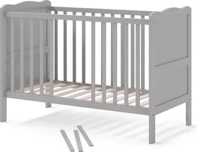 A gray baby crib is shown from a side angle on a white background.