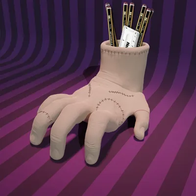 A hand-shaped pencil holder with pencils and a ruler inside, set against a striped purple background.
