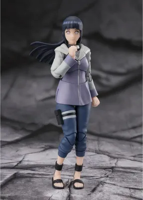 A full-body shot of an action figure of Hinata Hyuga from Naruto, standing on a rocky surface.