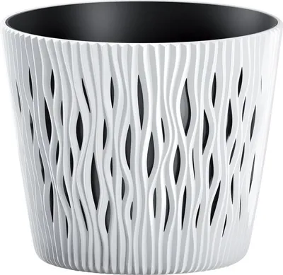 A white planter with a decorative, wavy pattern and a black interior.