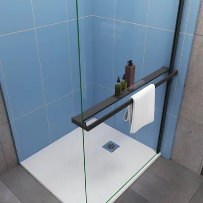 A close-up view of a shower shelf and towel holder mounted on a glass shower wall, with blue tiles in the background and a white shower tray.