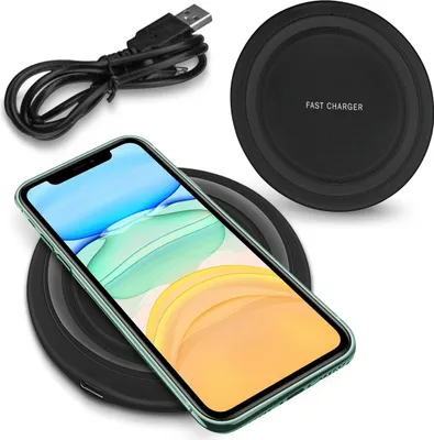 A smartphone is placed on a wireless charging pad, with a USB cable nearby.