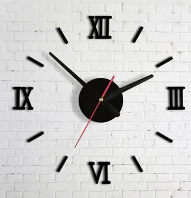 A black wall clock with Roman numerals on a white brick wall.