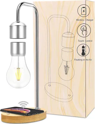 A levitating LED night light with a wireless charging base, shown next to its packaging which illustrates its features.