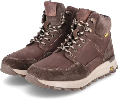 A pair of brown leather boots on a white background.