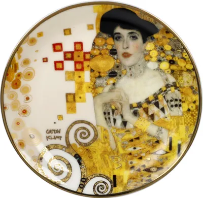 A decorative plate featuring a portrait of Adele Bloch-Bauer by Gustav Klimt.