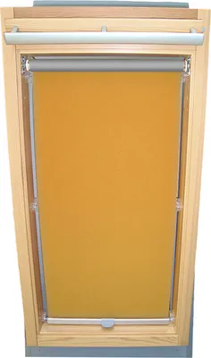 A yellow roller blind installed in a wooden skylight window frame.