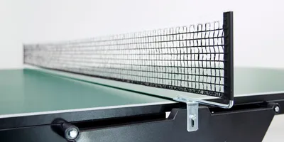 A close-up shot of a table tennis net and table.