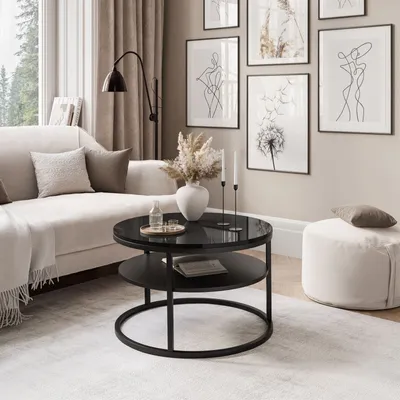 A modern living room with a couch, coffee table, and artwork.