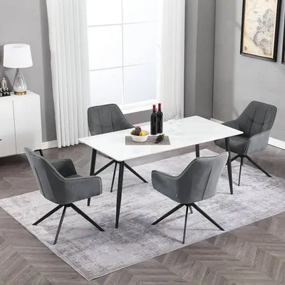 A dining set with a white marble-top table and four dark gray chairs in a well-lit room.