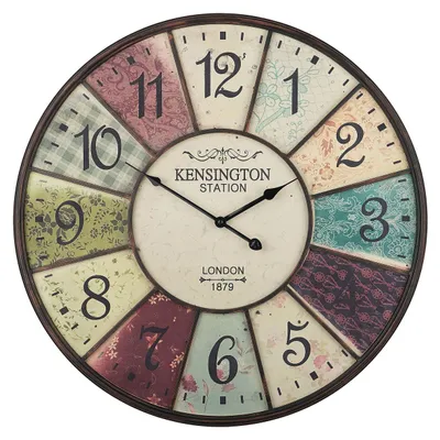A round wall clock with a vintage design, featuring numbers and decorative patterns on its face.