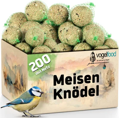 A box filled with bird food balls, with a blue tit bird in the foreground.