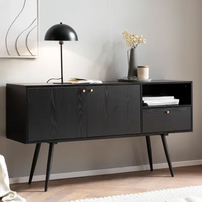A black sideboard with gold accents in a living room setting.