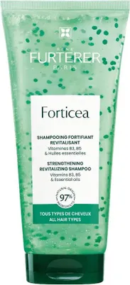 A green shampoo bottle with white text and green beads inside.