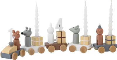 A wooden train decoration with animal figures and candles, likely for a birthday.