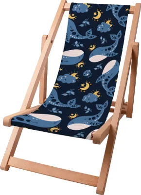 A wooden beach chair with a fabric seat featuring a pattern of whales, moons, and clouds.