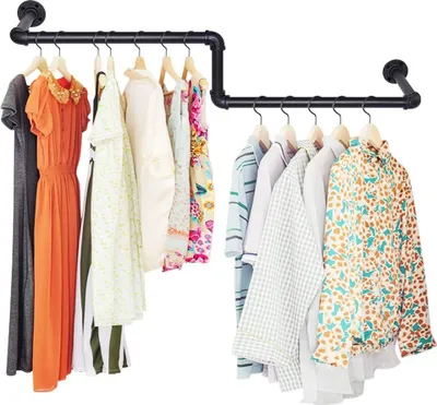 A clothing rack with several garments hanging on it, displayed against a white background.