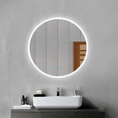 A modern bathroom vanity with a rectangular sink and a round LED mirror above it.
