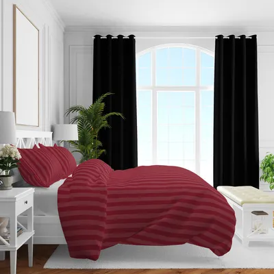 A bedroom scene with a bed, curtains, and a window.