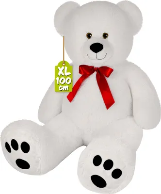 A white teddy bear with a red bow and a size tag.