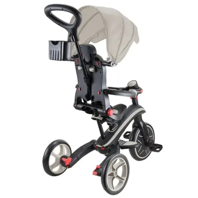 A close-up studio shot of a black and gray children's tricycle with a beige canopy.