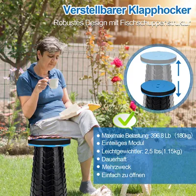 A woman sits on a portable folding stool in a garden while holding a cup and a book.