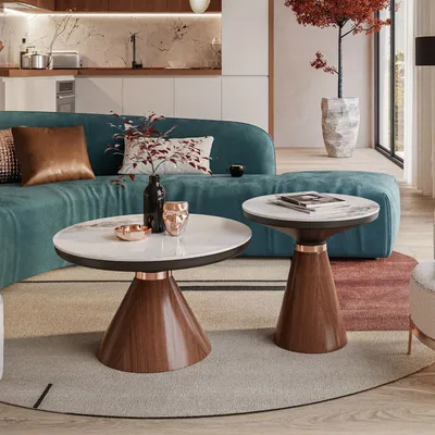 A modern living room with a teal sofa and two marble-top coffee tables.