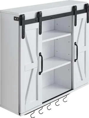 A white wall cabinet with sliding barn doors and open shelving.