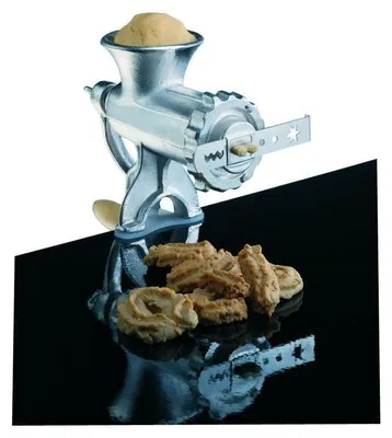A cookie press with dough and finished cookies on a reflective black surface.