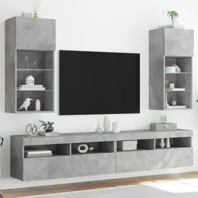 A modern living room entertainment center with a wall-mounted TV and shelving units.