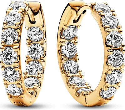 A pair of gold hoop earrings with clear stones.