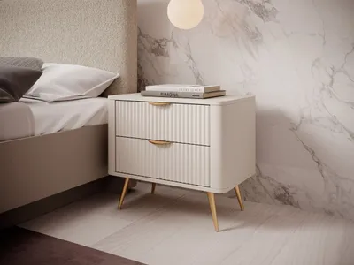 A modern bedroom setting with a nightstand next to a bed.