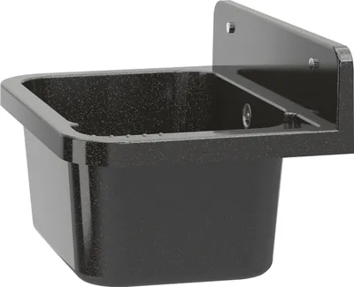 A black sink with a speckled finish is mounted on a wall.