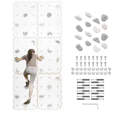 A child is climbing on a modular climbing wall system with various holds. The system is composed of four white panels, and the child is wearing athletic clothing.