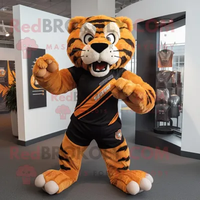 Produktbild von Rustikaler REDBROKOLY Maskottchen-Tiger mit Säbelzahntiger gekleidet in ein Rugby-Shirt und Schalklammern