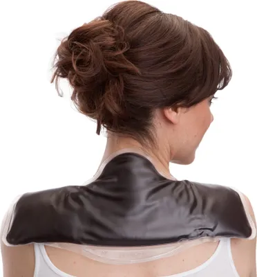 A woman wearing a black neck and shoulder heating pad.