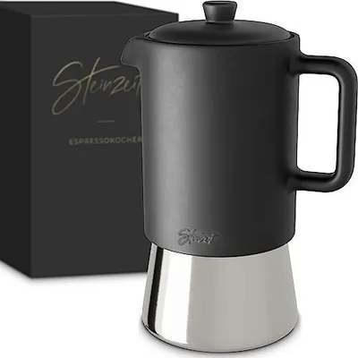 A black and silver stovetop espresso maker next to its packaging.