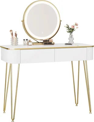 A white vanity table with gold legs and a round LED mirror, decorated with makeup brushes, perfume bottles, and a small vase of flowers.