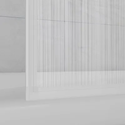 A close-up view of a white, three-panel shower screen for a bathtub, with a frosted plastic finish and vertical lines.