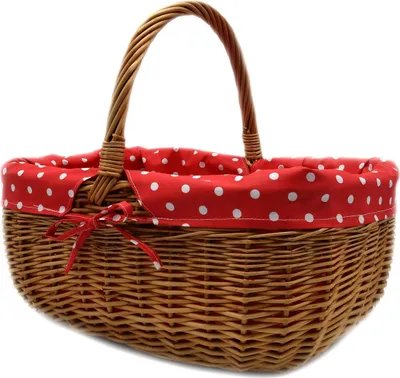 A wicker basket with a red and white polka dot fabric lining and a red ribbon tie.