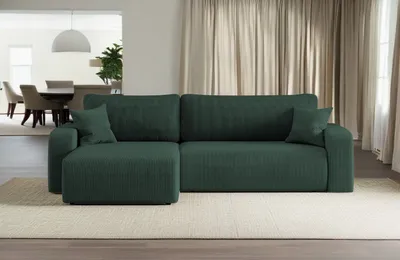 A green sectional sofa is shown in a living room setting.