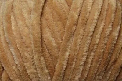 A close-up view of tan-colored yarn.