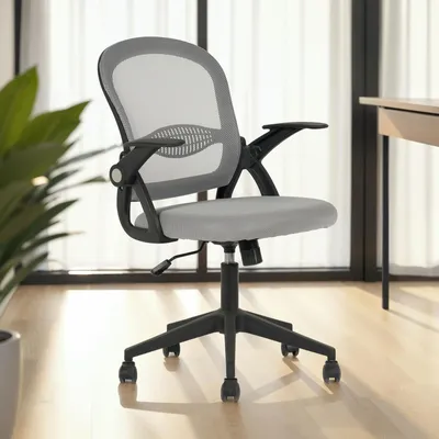 A gray office chair with black accents is shown in a room with a large window and light-colored flooring.