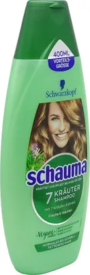 A green bottle of Schauma shampoo with a picture of a smiling woman on the label.