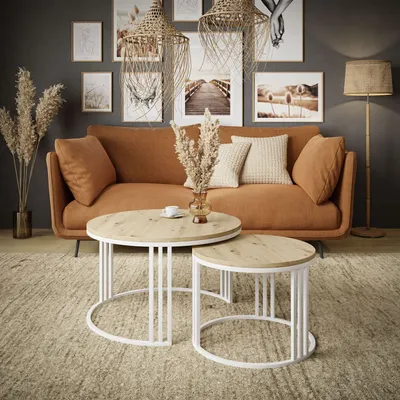 A living room scene with a sofa, coffee tables, and decor.