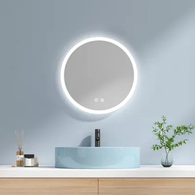 A modern bathroom vanity with a round LED mirror, a blue sink, and a black faucet.