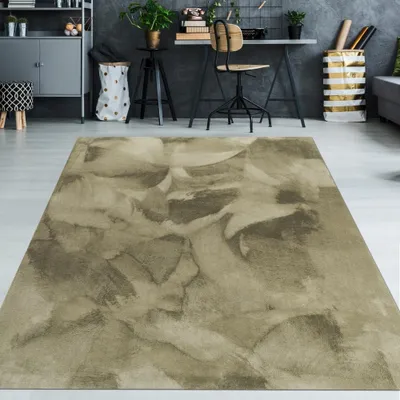A rug with a watercolor-like pattern is placed in a modern living room or office space.